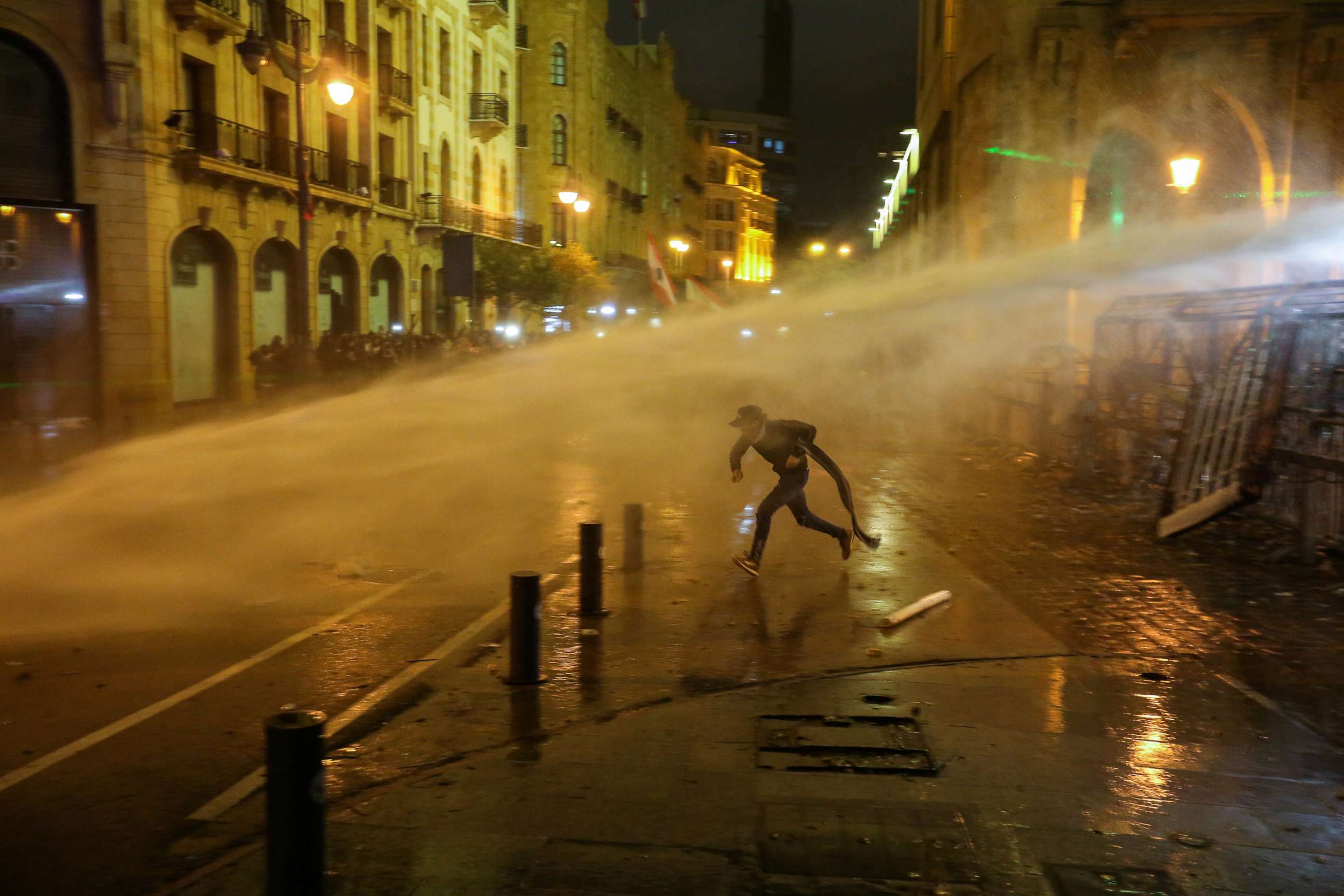 PHOTO: A demonstrator is hit by a water cannon during a protest against a ruling elite accused of steering Lebanon towards economic crisis in Beirut, Jan. 19, 2020.