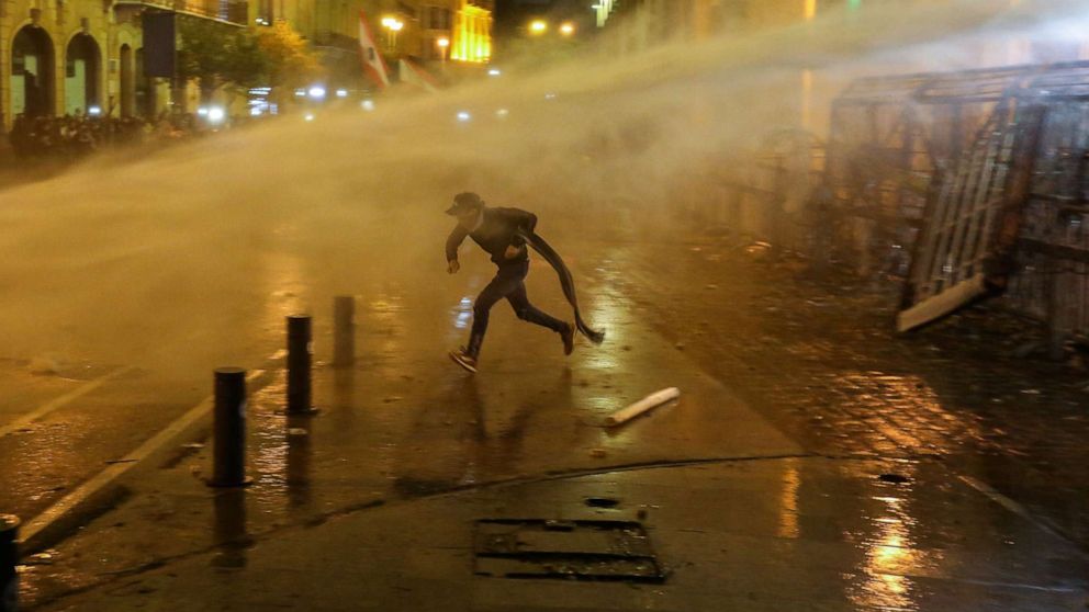 PHOTO: A demonstrator is hit by a water cannon during a protest against a ruling elite accused of steering Lebanon towards economic crisis in Beirut, Jan. 19, 2020.