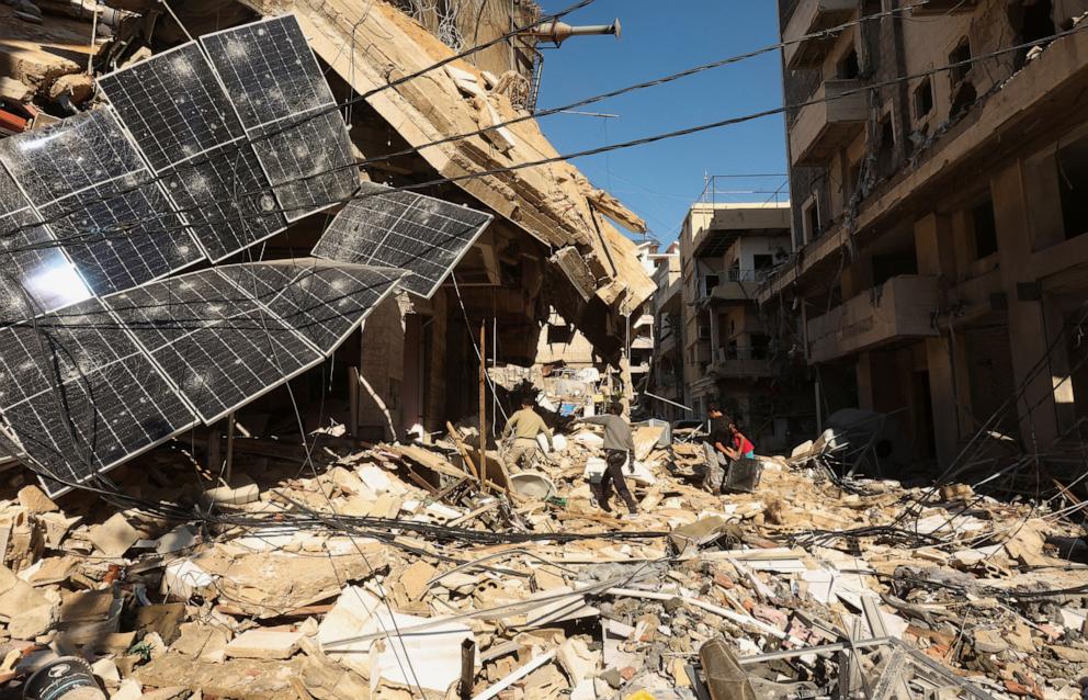 PHOTO: People walk on rubble of damaged buildings, after a ceasefire between Israel and Hezbollah, in Tyre, southern Lebanon, Nov. 30, 2024