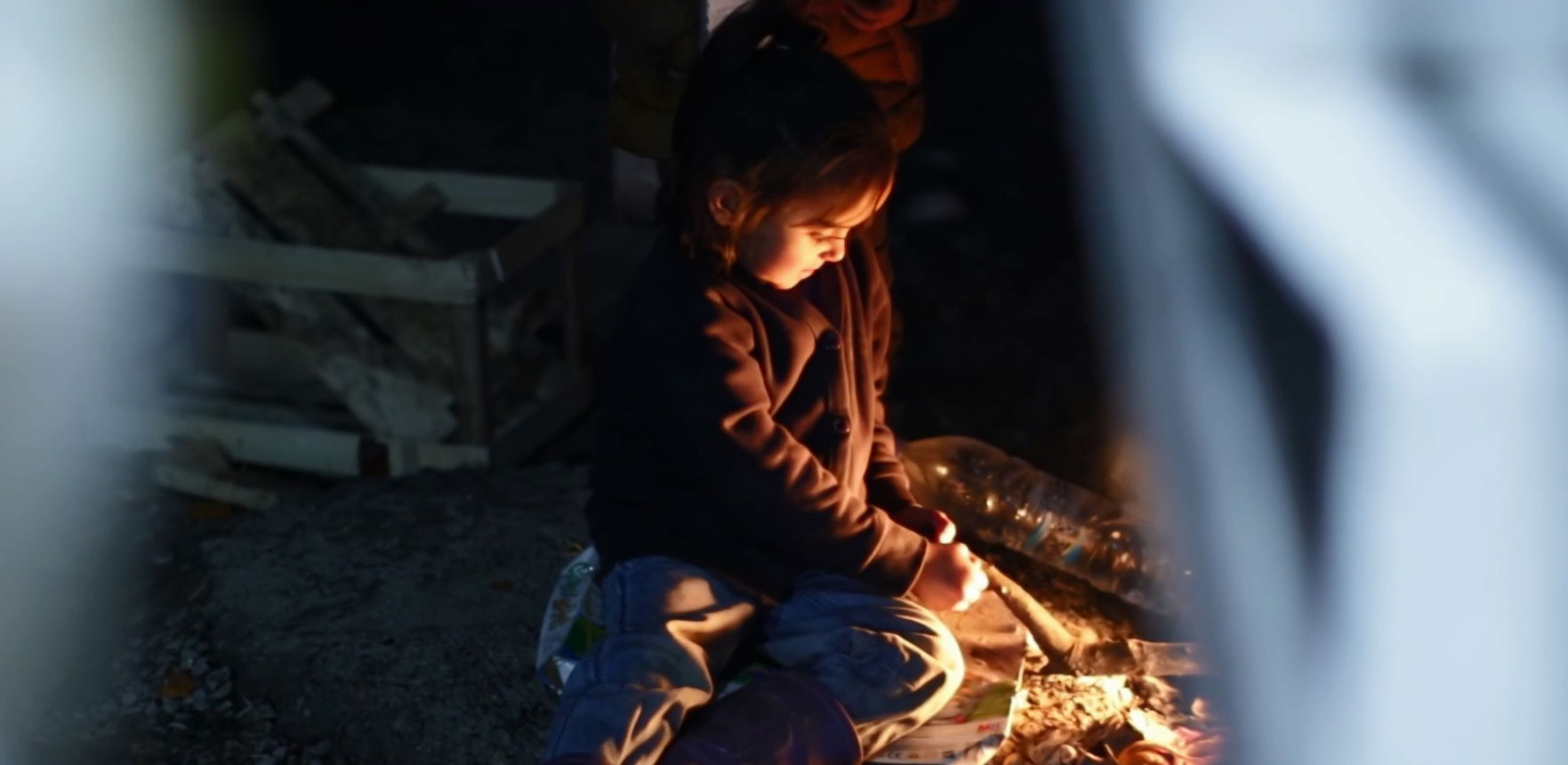 PHOTO: In Lesbos' Moria refugee camp, children gather around fires to keep warm.