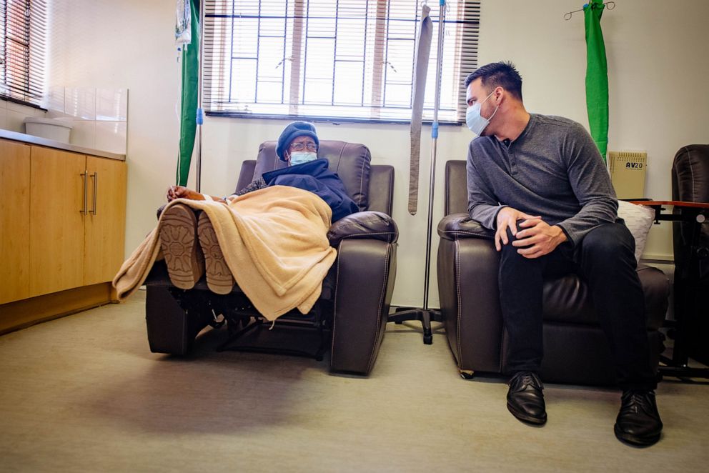PHOTO: Alejandro Nava visits with a patient at Senkatana Oncology Clinic in Lesotha, South Africa.