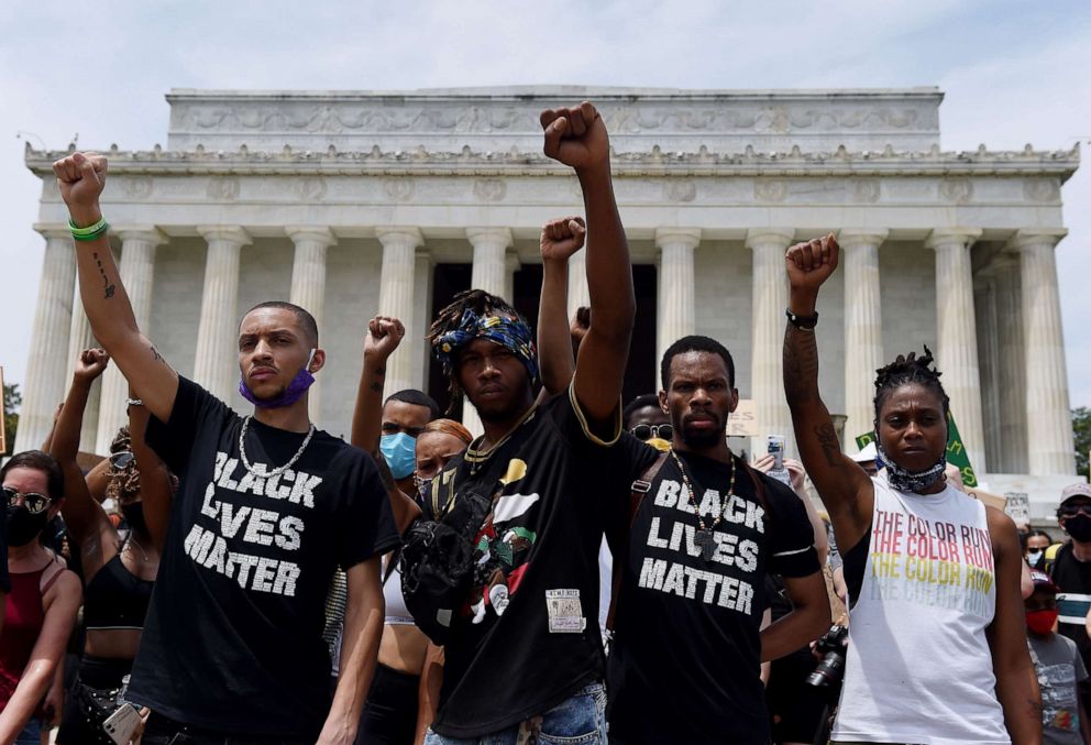 PHOTO: Demonstrators raise their fists at the Lincoln Memorial during a protest against police brutality and racism, on June 6, 2020, in Washington.