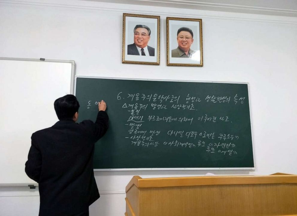 PHOTO: A literary teacher writes on a blackboard in a classroom at Kim Il Sung University, Pyongyang, North Korea