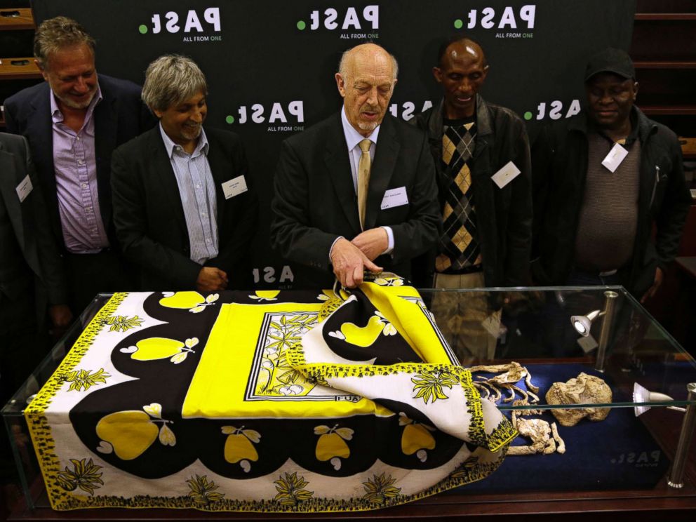PHOTO: Ron Clarke, a professor from the Evolutionary Studies Institute at the University of the Witwatersrand, center, unveils the virtually complete Australopithecus fossil Little Foot in Johannesburg, South Africa, Dec. 6, 2017.