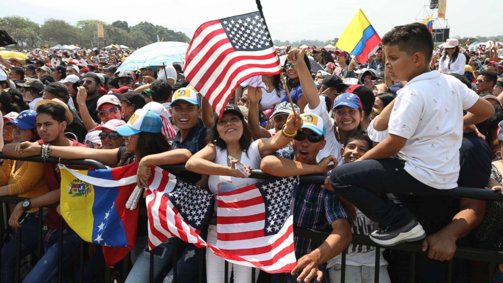 PHOTO: Fans wave Venezuelan and United States flags during the Venezuela Aid Live concert on the Colombian side of the Tienditas International Bridge near Cucuta, Colombia, Feb. 22, 2019.