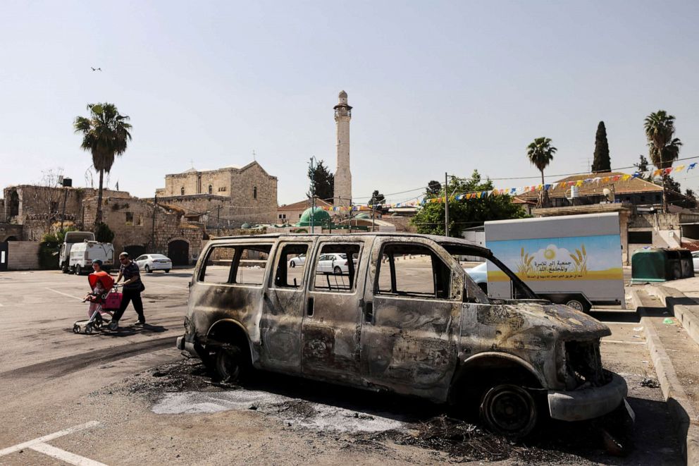 PHOTO: A burnt vehicle is seen after violent confrontations between Israeli Arab demonstrators and police in the city of Lod, Israel, May 12, 2021.
