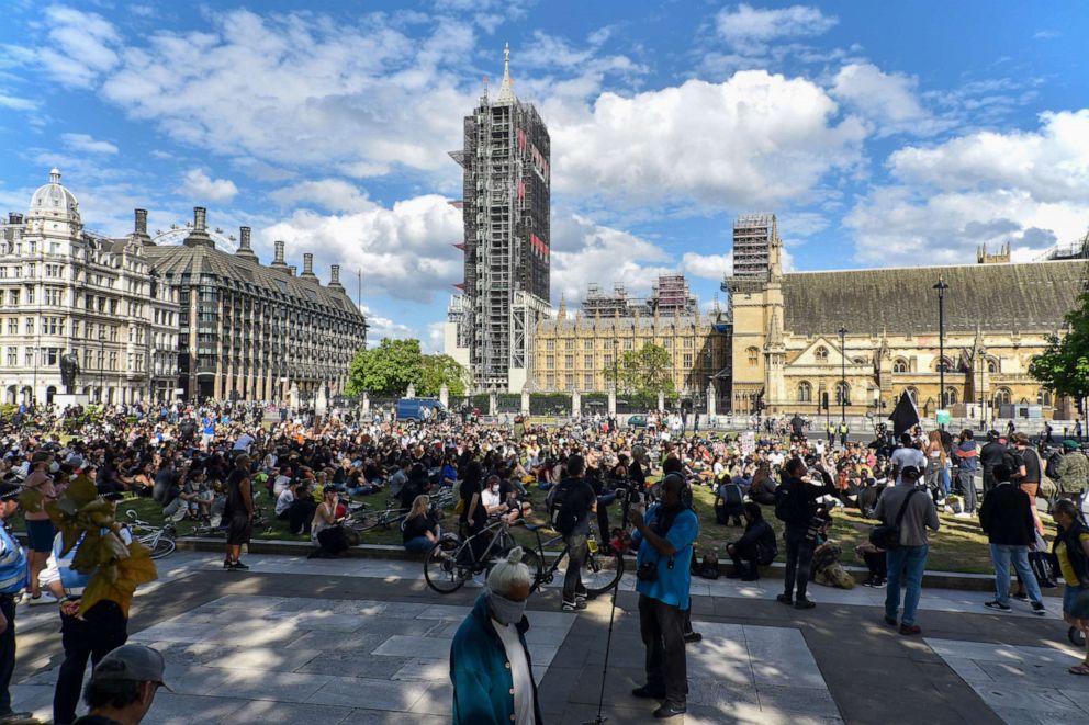 PHOTO: Black Lives Matter protesters sit in  front of the Houses of Parliament as activists give speeches during a demonstration, June 21, 2020, in London.