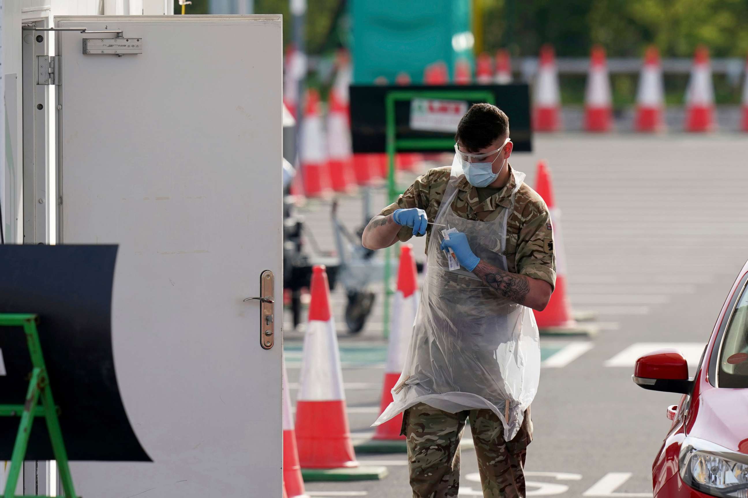 PHOTO: A soldier walks back to a hut after testing a NHS (National Health Service) worker for Covid-19 at a drive-through testing centre, in Manchester, northern England, April 9, 2020.