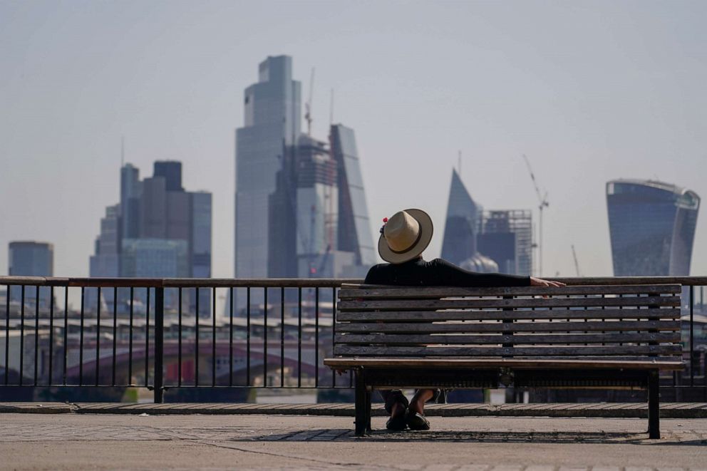 PHOTO: A man sits on a bench on the south bank of river Thames, in London, on July 18, 2022.