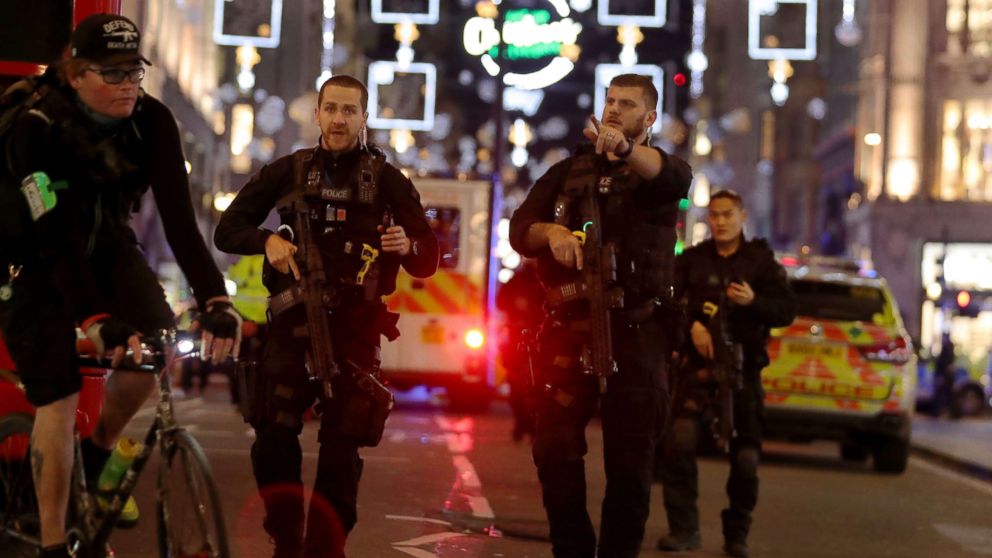 Armed police gesture as they walk along Oxford street following an incident in central London on Nov. 24, 2017.