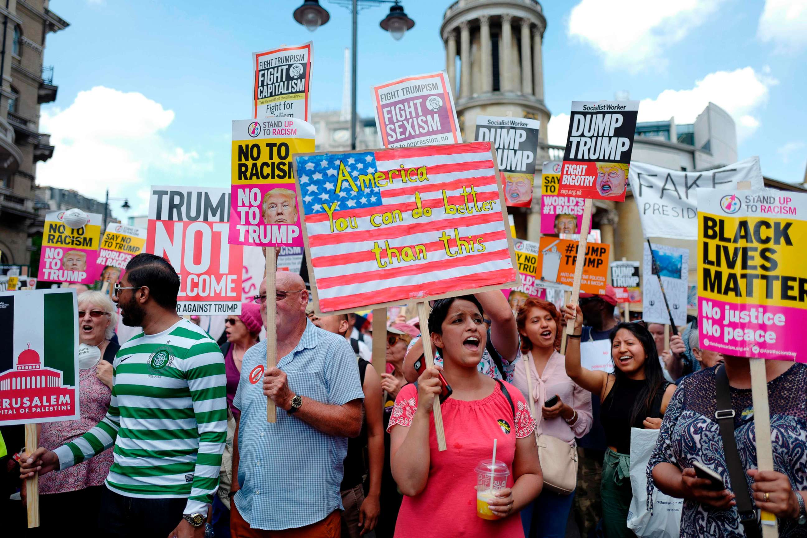 PHOTO: Protesters gather with placards to take part in a march and rally against President Donald Trump's visit to Britain, on July 13, 2018 in London.
