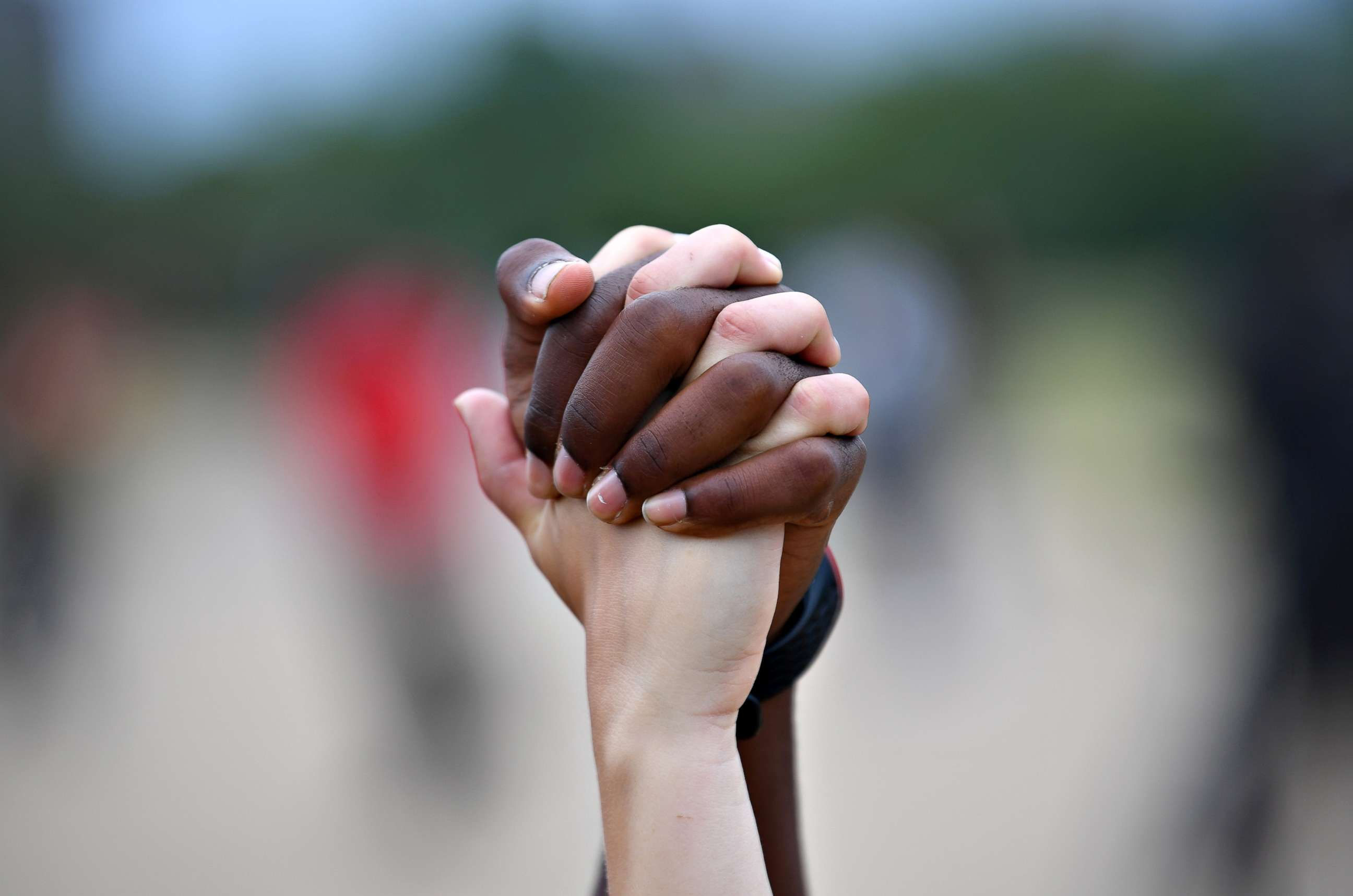 PHOTO: A man and a woman hold hands aloft in Hyde Park during a Black Lives Matter protest, in London, UK, following the death of George Floyd who died in police custody in Minneapolis, Minn., June 3, 2020.