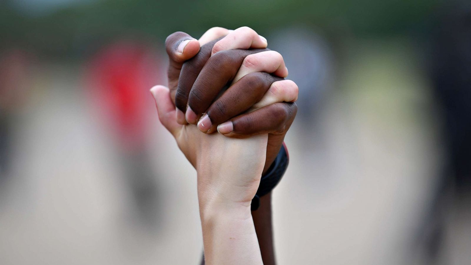 PHOTO: A man and a woman hold hands aloft in Hyde Park during a Black Lives Matter protest, in London, UK, following the death of George Floyd who died in police custody in Minneapolis, Minn., June 3, 2020.