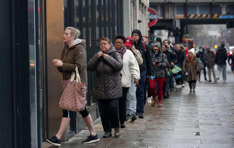 PHOTO: People queue outside of a grocery store, as the spread of the coronavirus disease (COVID-19) continues, in London, England, March 19, 2020.