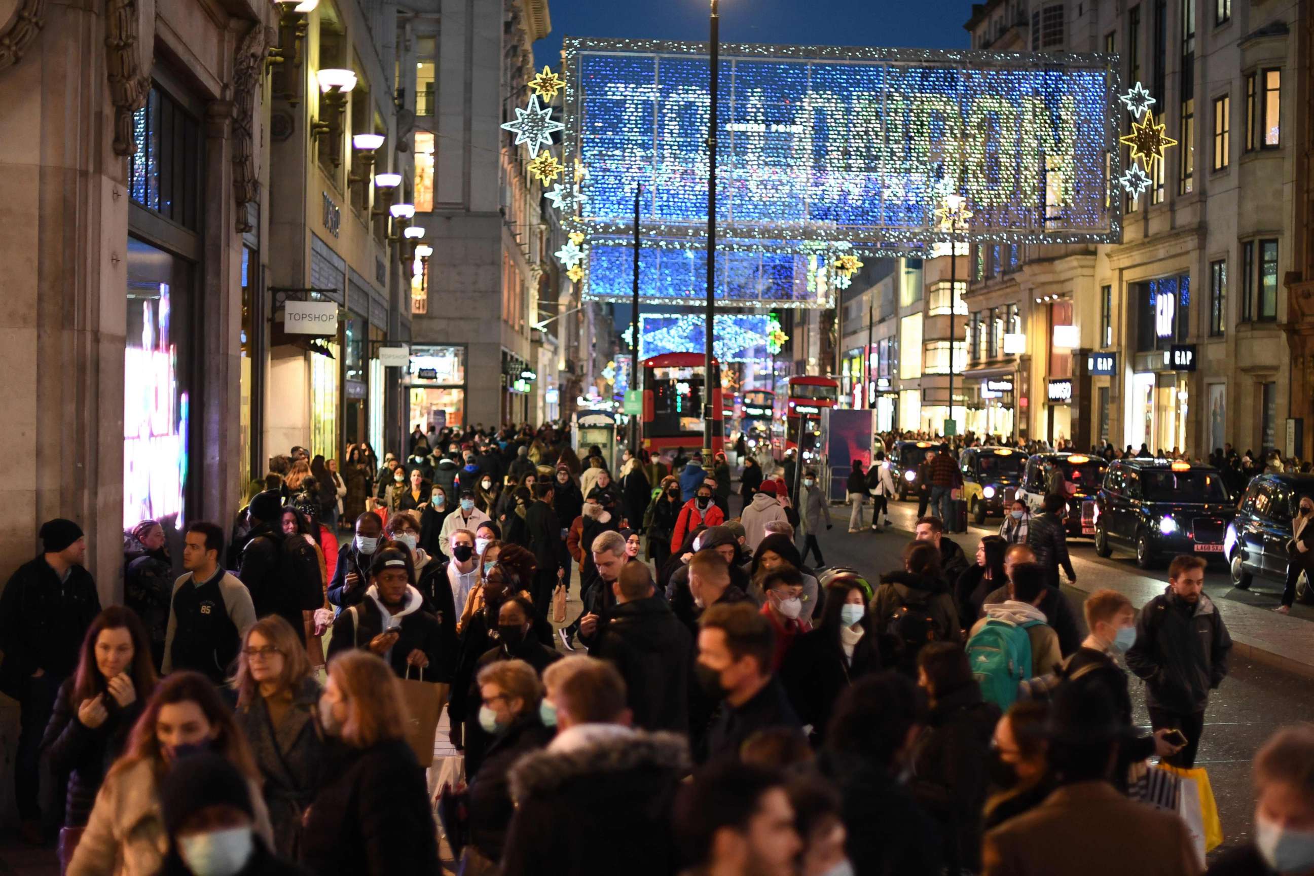 PHOTO: Christmas illuminations are seen above shoppers on Regent Street in the main high-street shopping area of London, Dec. 15, 2020 ahead of fresh measures for the capital amid rising novel coronavirus infection rates.