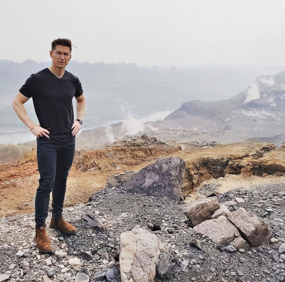 PHOTO: ABC correspondent James Longman stands near an abandoned mine in eastern India. The smoke billowing from the ground is co2 filled vapor, pouring out of cracks in the ground.