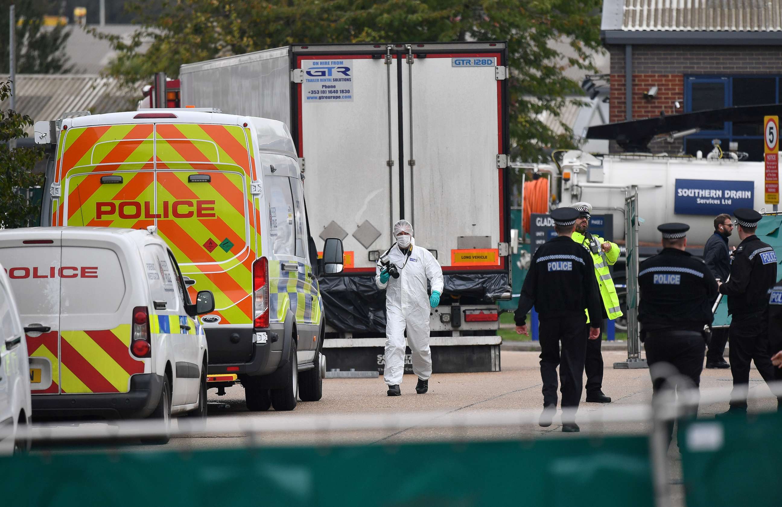 PHOTO: British Police officers in forsensic suits work near a lorry, found to be containing 39 dead bodies, inside a police cordon at Waterglade Industrial Park in Grays, east of London, on Oct. 23, 2019.