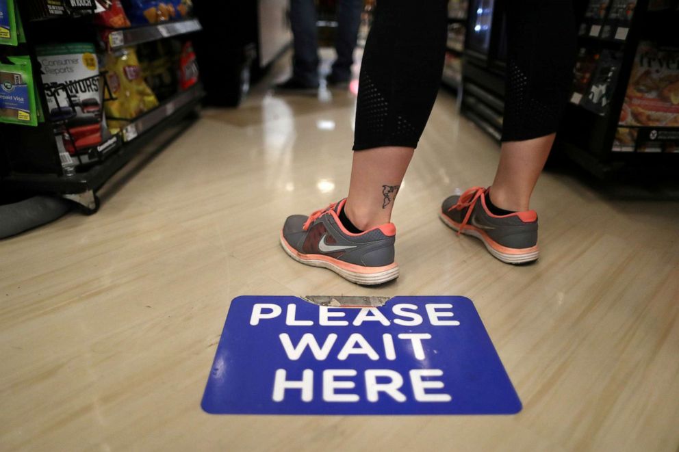 PHOTO: Social distancing decals are seen on the floor of a grocery store  in an effort to prevent the spread of coronavirus disease (COVID-19), in Los Angeles, Calif., March 30, 2020.
