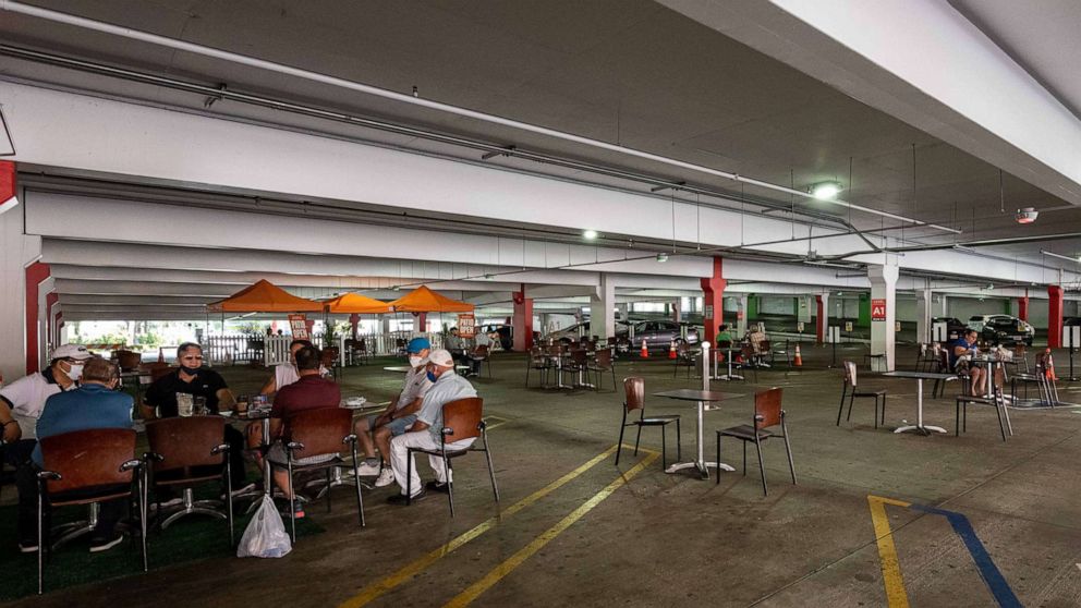 PHOTO: People dine in the parking garage dining area at the Glendale Galleria parking structure in Los Angeles, Aug. 11, 2020.