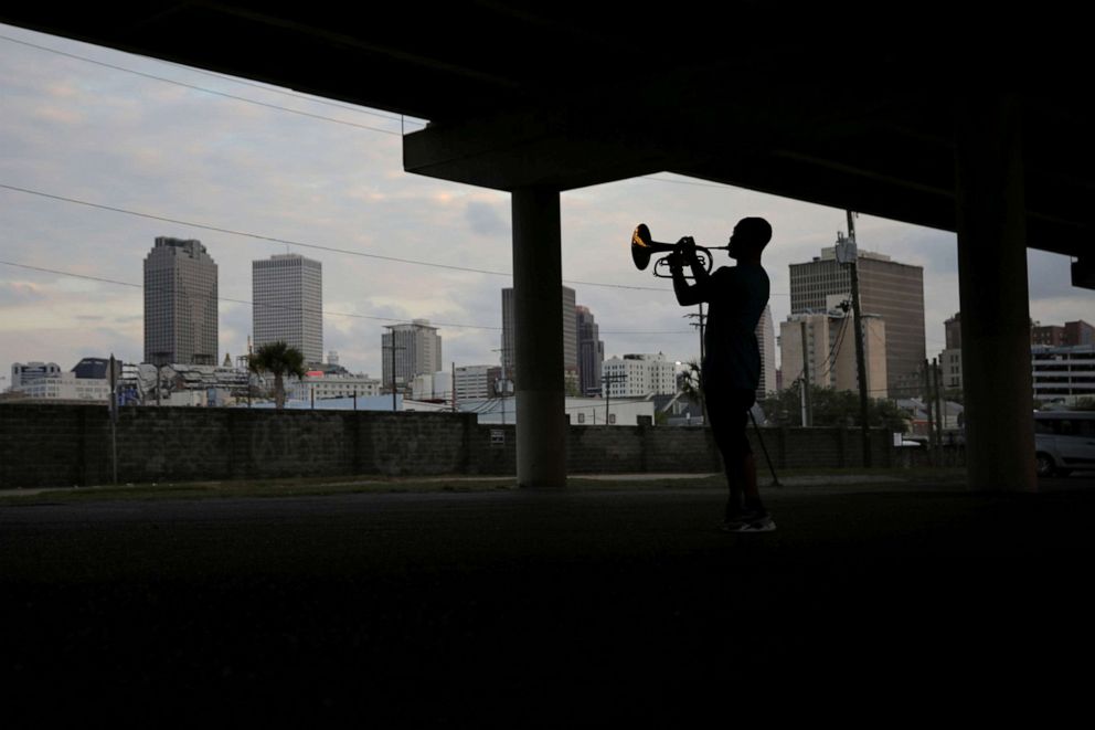 PHOTO: Lloyd Robinson, a local musician plays a marching mellophone under a highway during a gathering with musicians friends as the spread of coronavirus disease (COVID-19) continues, in New Orleans, April 6, 2020.