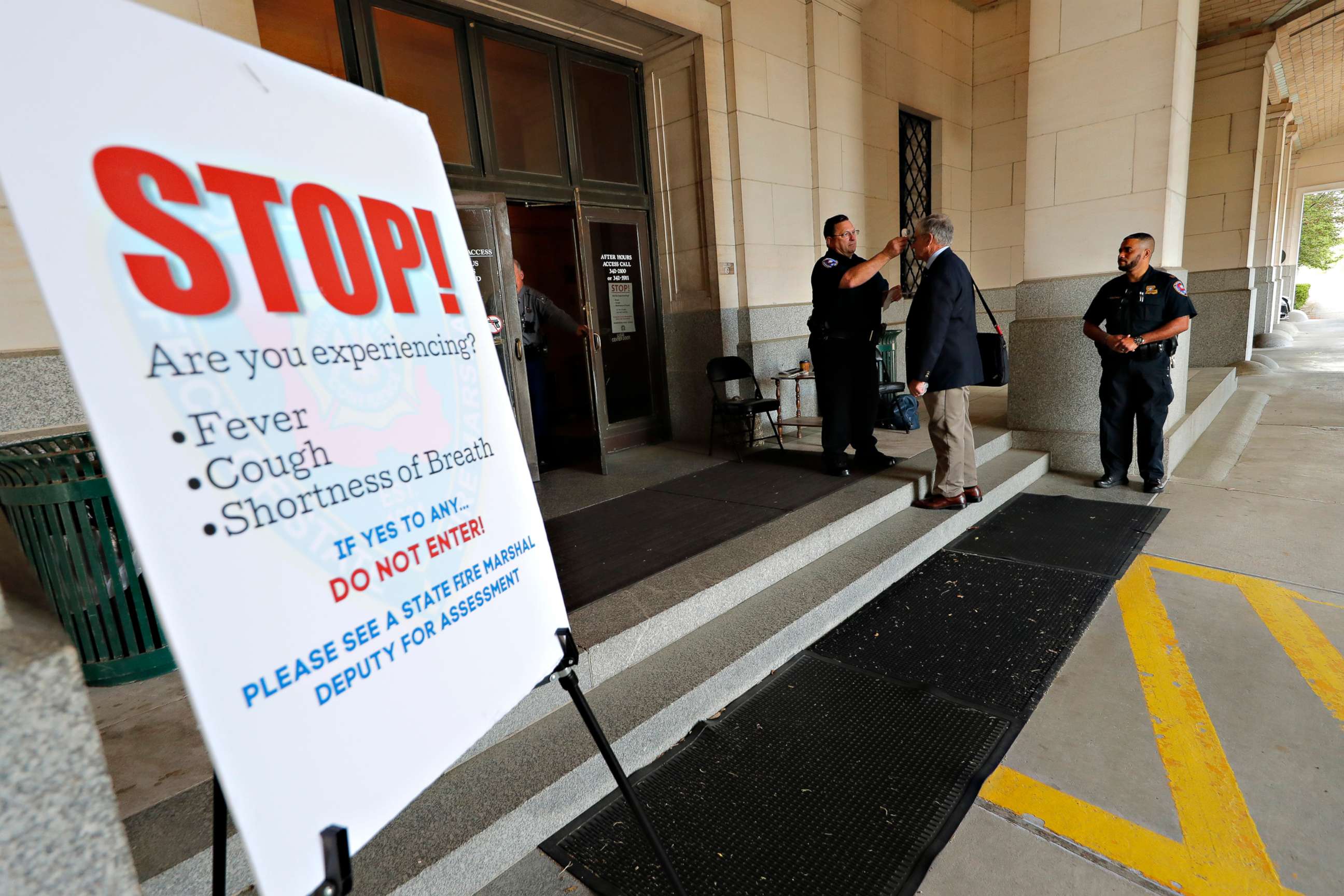 PHOTO: State Sen. Eddie Lampert has his temperature taken as he arrives at the State Capitol in Baton Rouge, La., March 31, 2020.