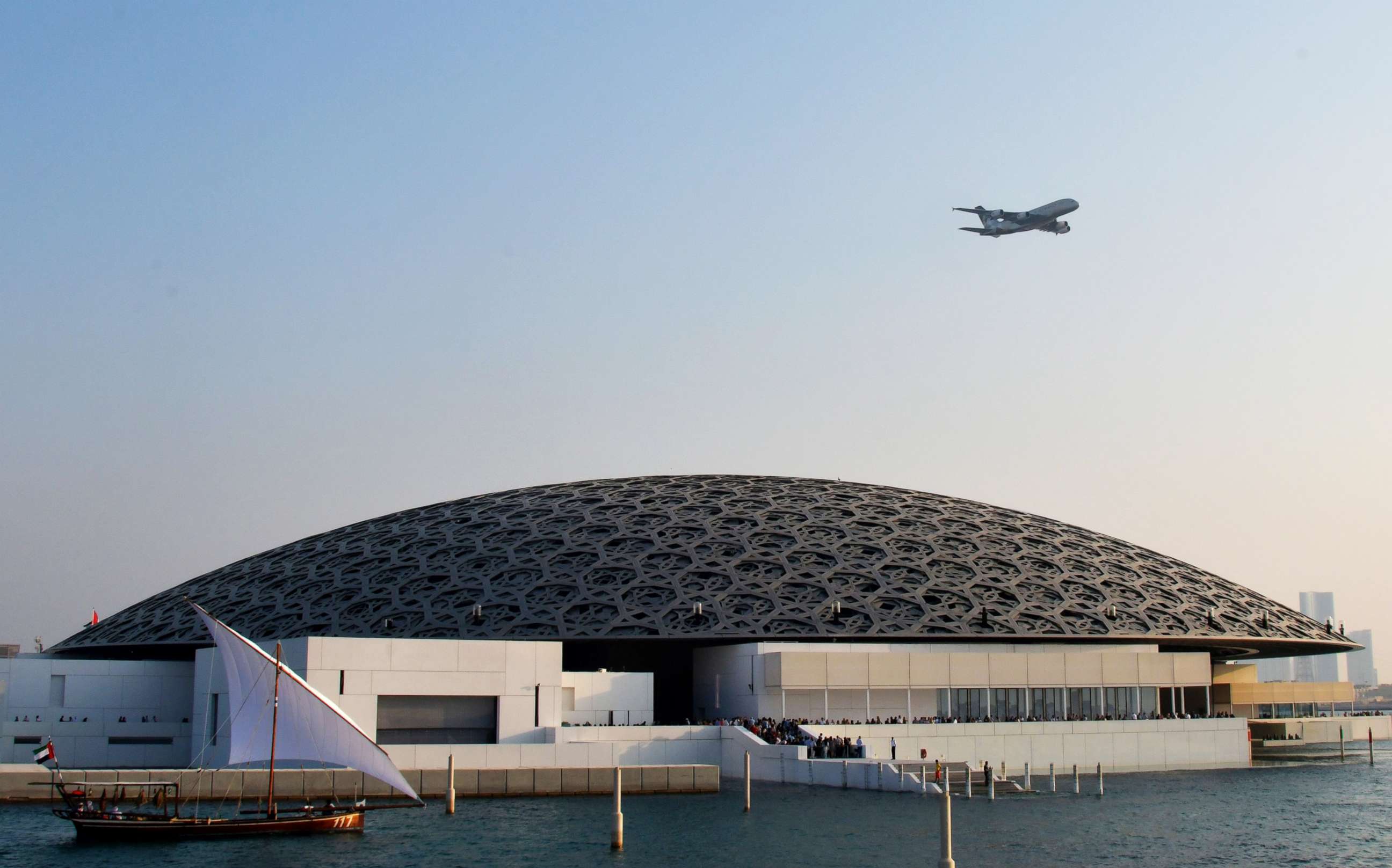 PHOTO: An Ethiad A380 flies over the Louvre Abu Dhabi Museum designed by French architect Jean Nouvel on Nov. 11, 2017, during its official opening to public on Saadiyat island in the Emirati capital. 
