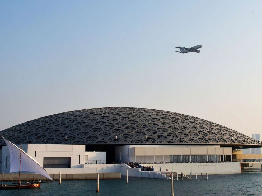 PHOTO: An Ethiad A380 flies over the Louvre Abu Dhabi Museum designed by French architect Jean Nouvel on Nov. 11, 2017, during its official opening to public on Saadiyat island in the Emirati capital.