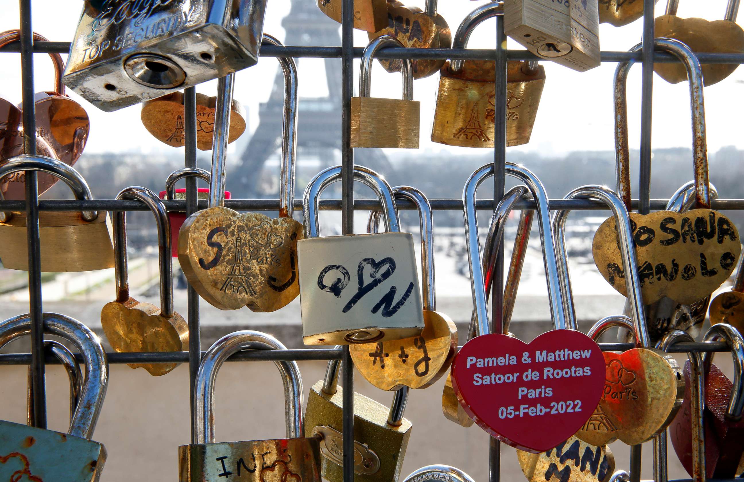 PHOTO: Heart-shaped love padlocks hang on a grid at 'Place du Trocadero' in front of the Eiffel Tower ahead of Valentine's Day on Feb. 11, 2022 in Paris.