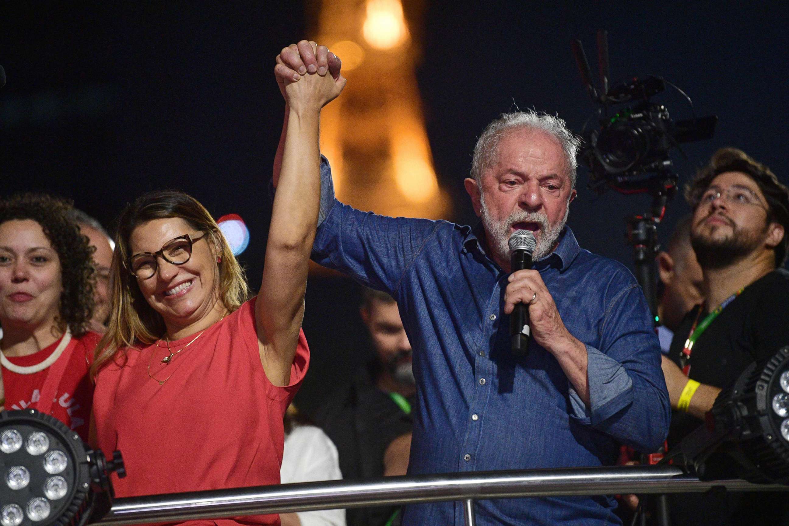 PHOTO: Brazilian president-elect Luiz Inacio Lula da Silva holds the hand of his wife, Rosangela "Janja" da Silva, while delivering a speech to supporters after winning the presidential run-off election, in Sao Paulo, Brazil, on Oct. 30, 2022.