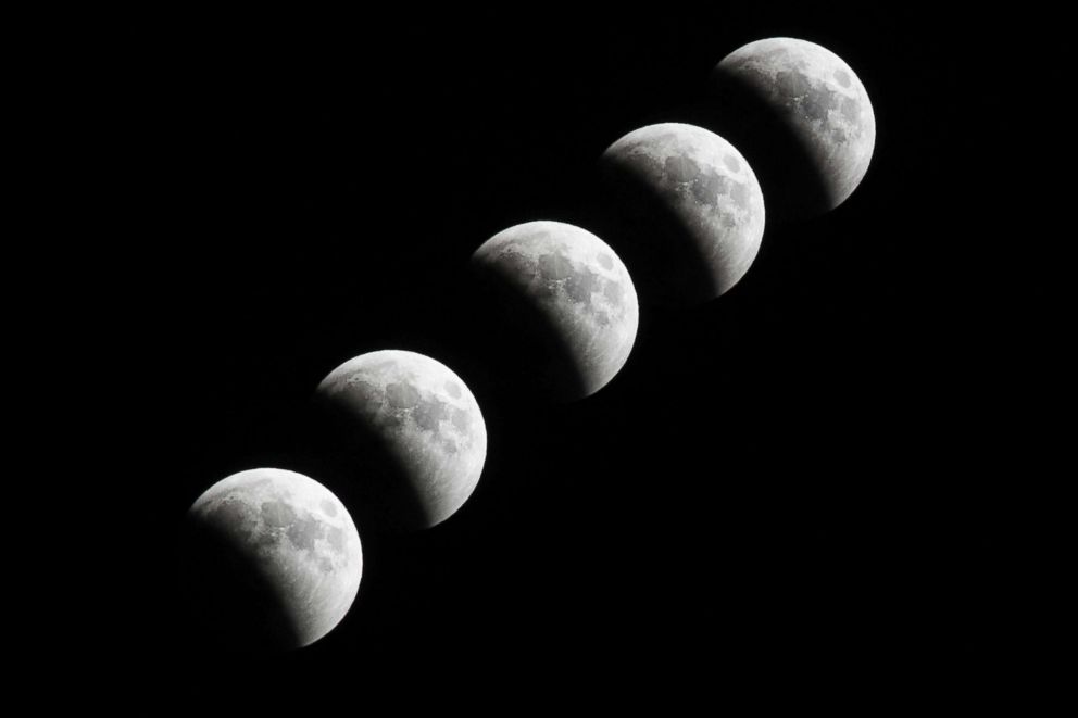 PHOTO: A multiple exposure photos shows the Moon over Idlib, Syria, July 27, 2018. 