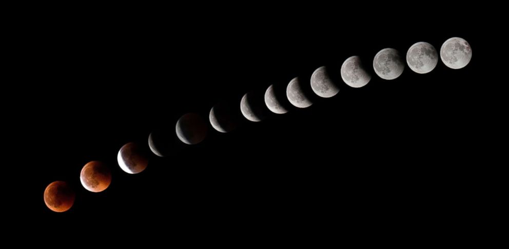 PHOTO: This combination of 14 pictures put together and taken on July 27, 2018, shows the moon during a total lunar eclipse near to La Puente town, canary Spanish island of Tenerife.