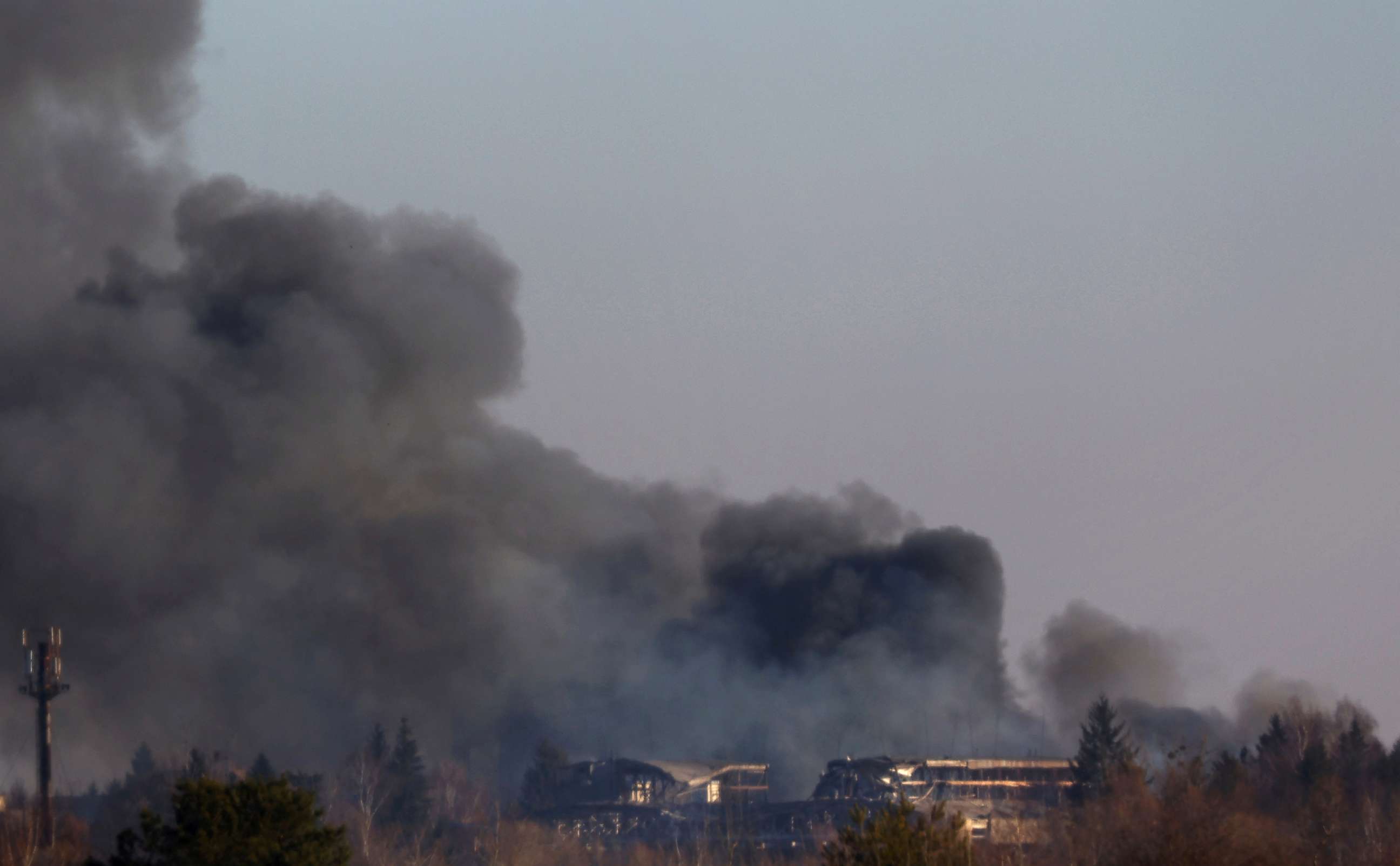 PHOTO: Smoke rises from a factory building near Lviv airport, in Lviv, Ukraine, March 18, 2022. 