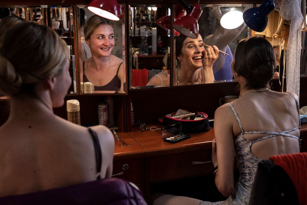 PHOTO: Ballet dancers Virtoriya Zvanych and Mariana Hers share a laugh as they put on makeup backstage before the performance, on June 10, 2022 in Lviv, Ukraine.