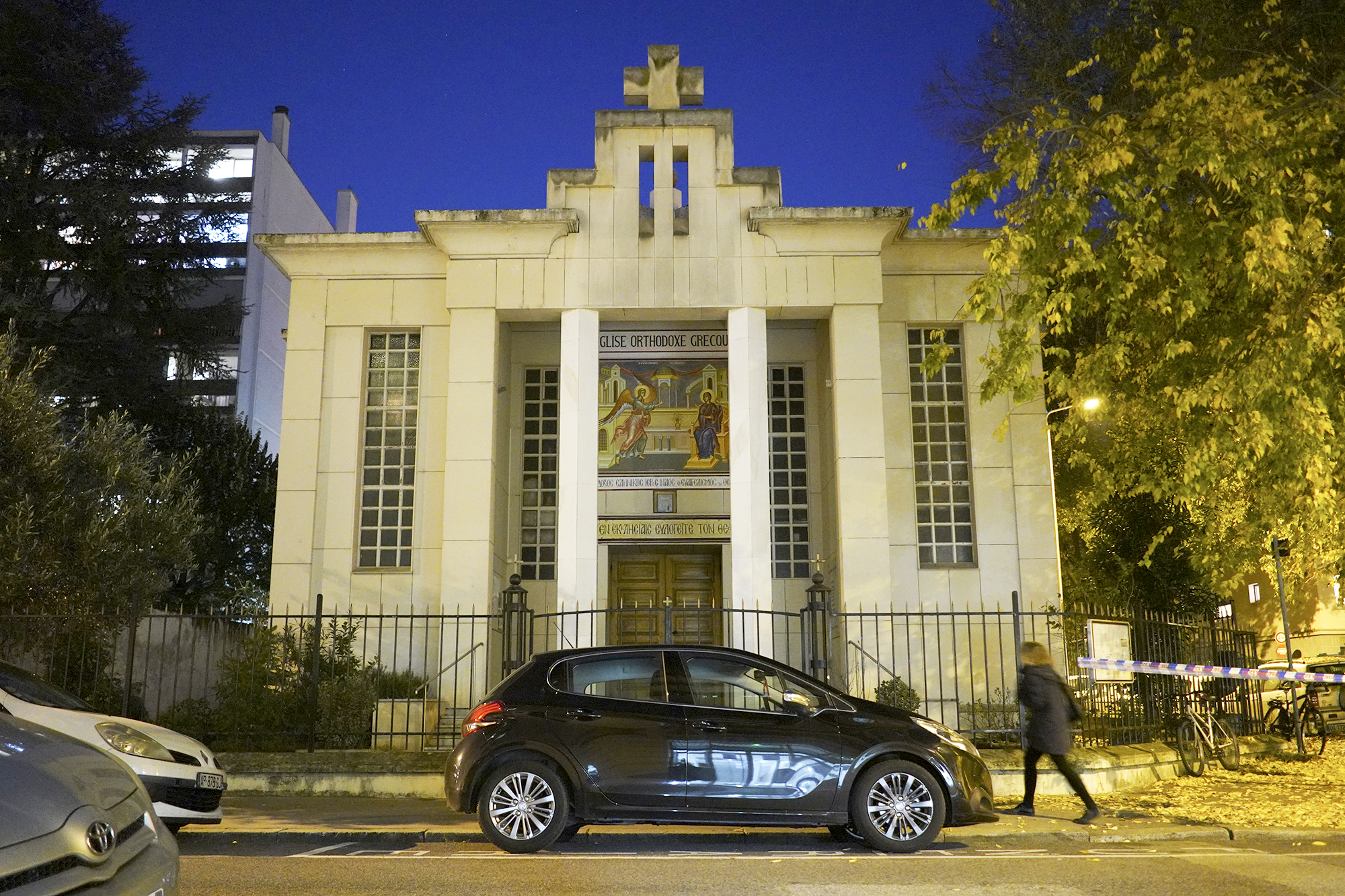 PHOTO: A woman walks past the Greek Orthodox church after a priest was shot while he was closing his church in the city of Lyon, France, Oct. 31, 2020.