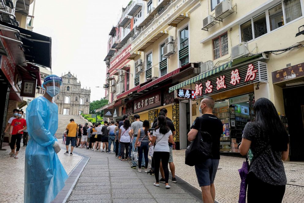 FILE PHOTO: People queue for COVID-19 testing in Macau, China, June 20, 2022.
