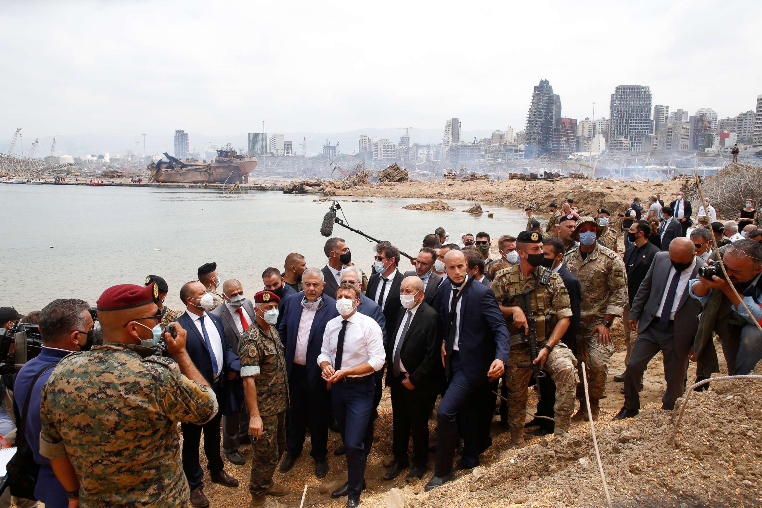 PHOTO: French President Emmanuel Macron, center, visits the devastated site of the explosions at the port of Beirut, Aug.6, 2020.