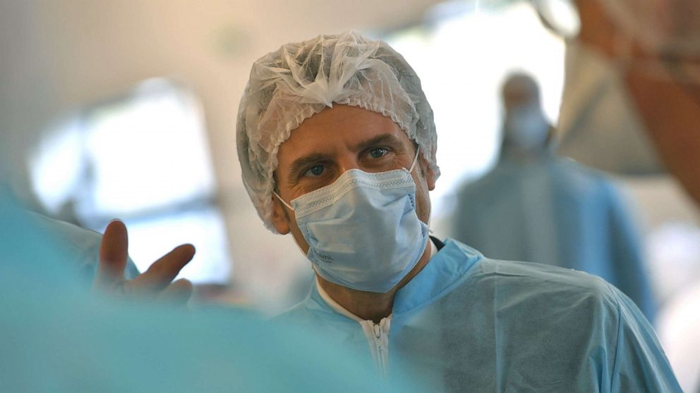 PHOTO: French President Emmanuel Macron wears a protective suit and face mask as he visits the Kolmi-Hopen protective face masks factory in Saint-Barthelemy-d'Anjou near Angers, central France, March 31, 2020.