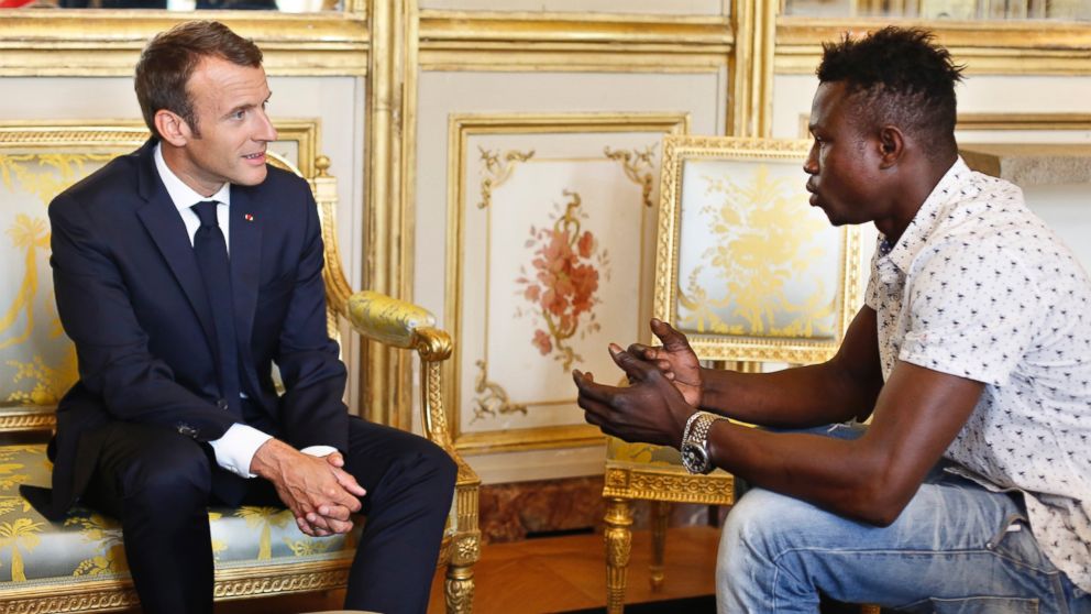 French President Emmanuel Macron, left, meets with Mamoudou Gassama, 22, from Mali, at the presidential Elysee Palace in Paris, Monday, May, 28, 2018.