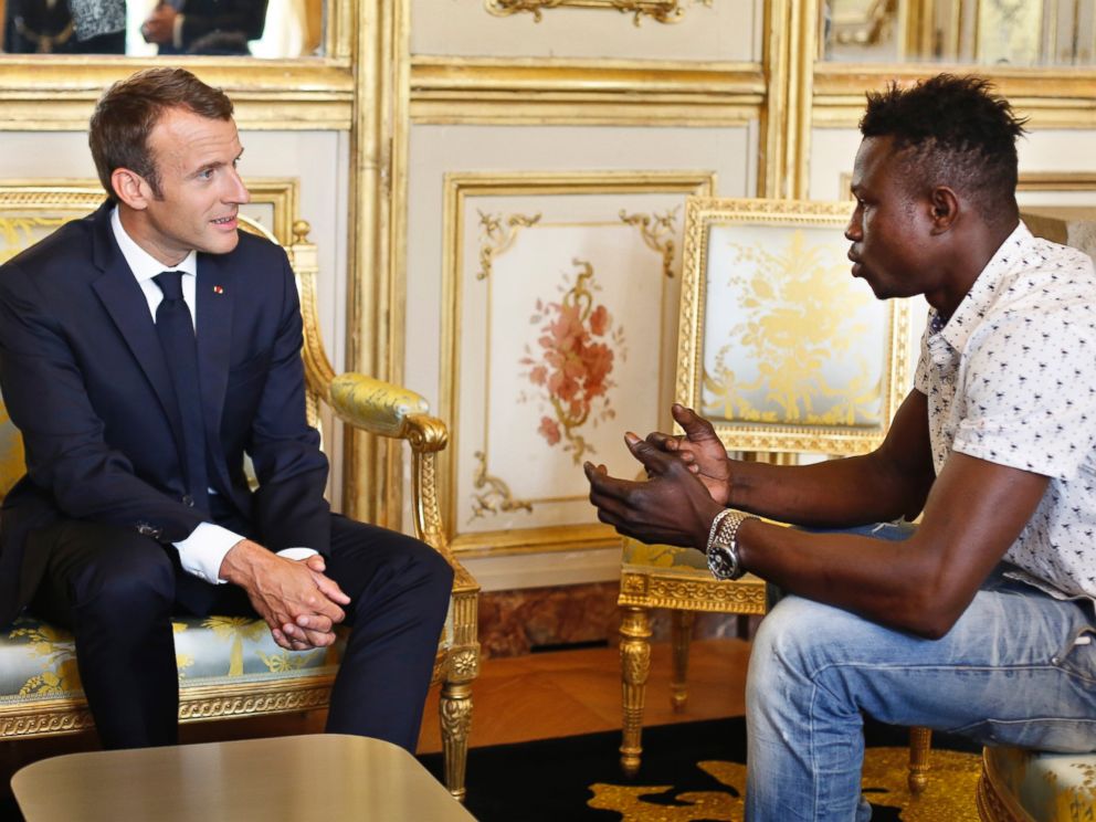 French President Emmanuel Macron, left, meets with Mamoudou Gassama, 22, from Mali, at the presidential Elysee Palace in Paris, Monday, May, 28, 2018.