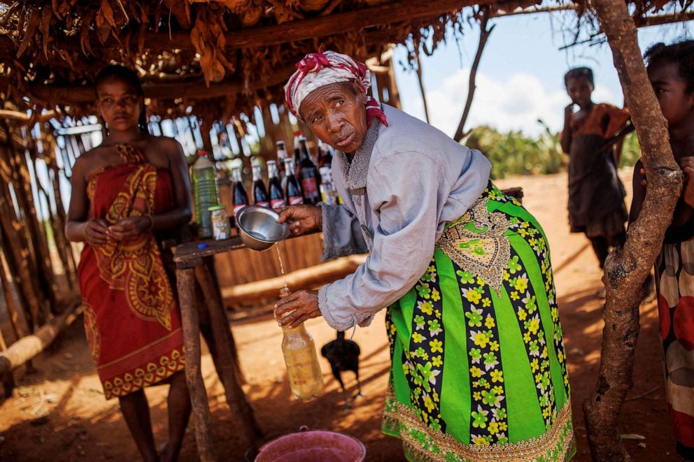 PHOTO: A woman fills a plastic canister with water at a road stop in the Sampona commune, Madagascar, Feb. 11, 2022.