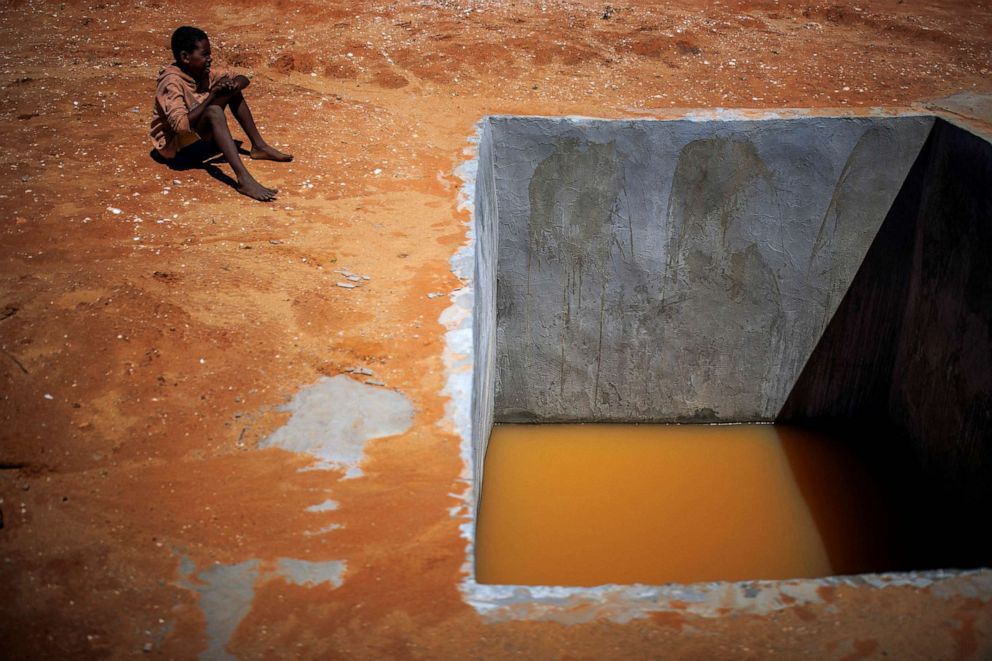 PHOTO: A boy sits next to a well in the village of Ambory, Erada commune, Madagascar, Feb. 16, 2022.