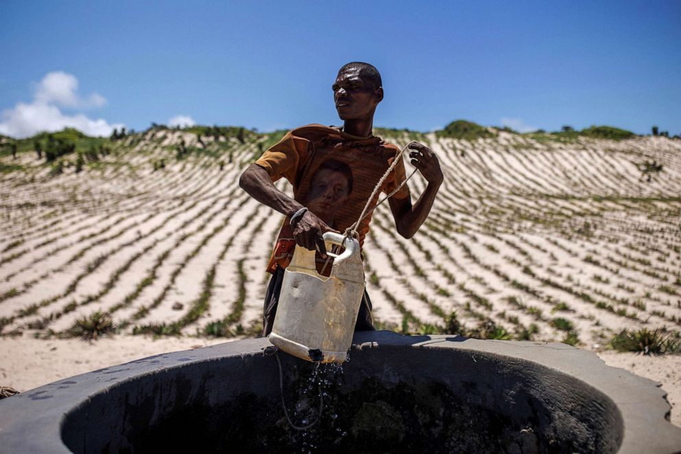 PHOTO: A local pulls water from a well in front of a sand dune in Faux Cap, Madagascar, Feb. 13, 2022.