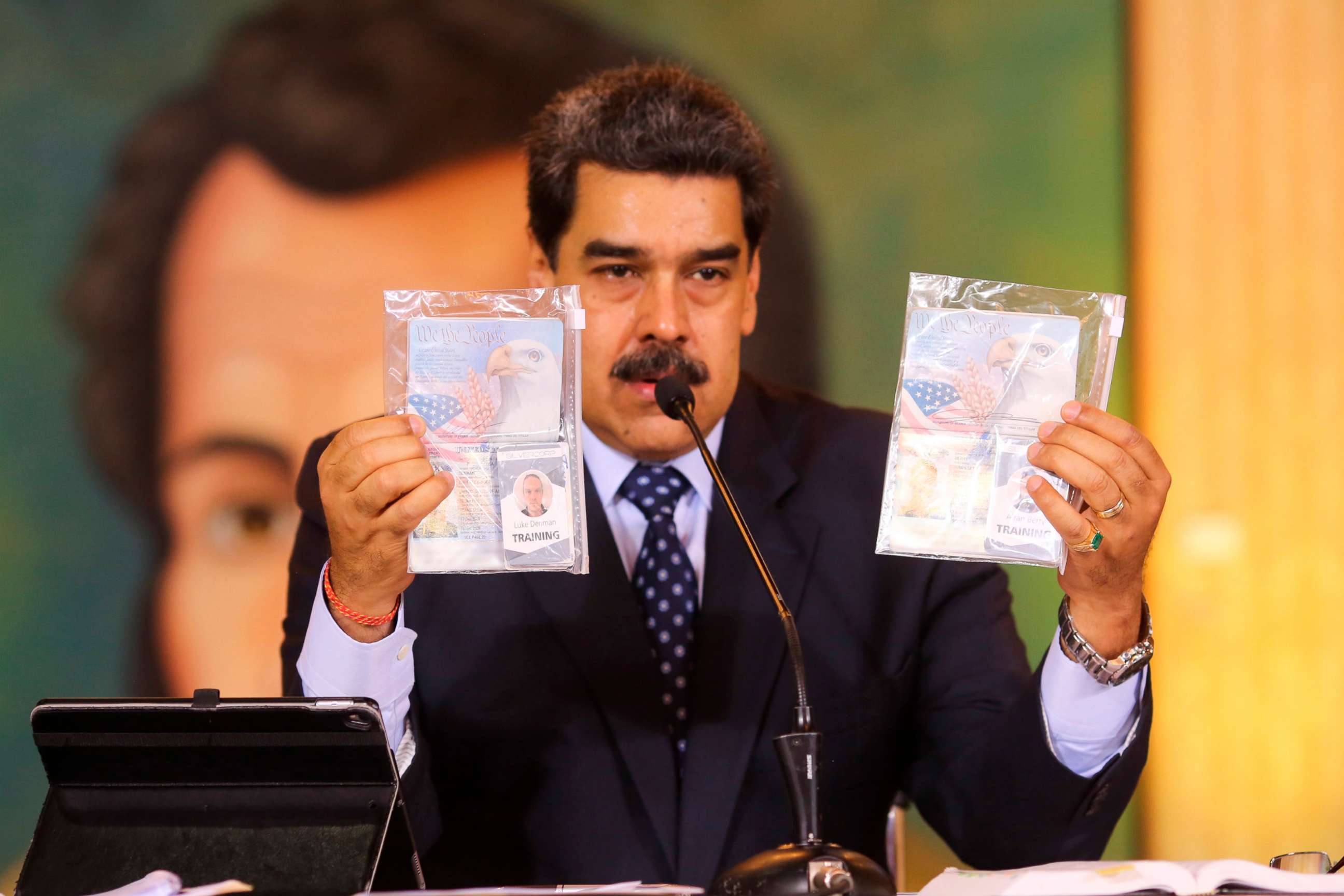 PHOTO: President Nicolas Maduro shows what Venezuelan authorities claim are identification documents of former U.S. special forces and U.S. citizens Airan Berry, right, and Luke Denman in Caracas, Venezuela, May 6, 2020.