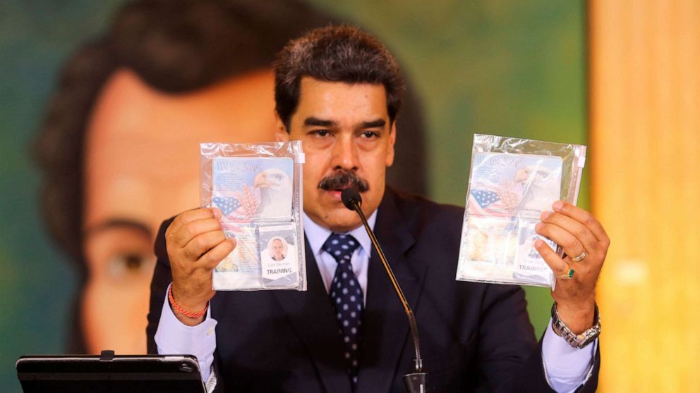 PHOTO: President Nicolas Maduro shows what Venezuelan authorities claim are identification documents of former U.S. special forces and U.S. citizens Airan Berry, right, and Luke Denman in Caracas, Venezuela, May 6, 2020.