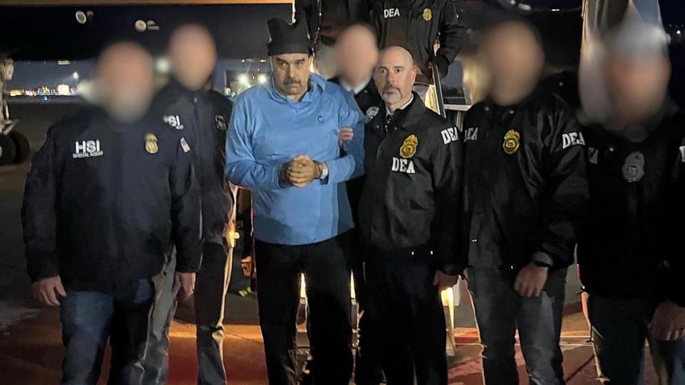 PHOTO: Venezuela's President Nicolas Maduro is escorted by Administrator of the U.S. Drug Enforcement Administration, Terry Cole after arriving at Stewart Air National Guard Base in Newburgh, New York, January 3, 2026. 
