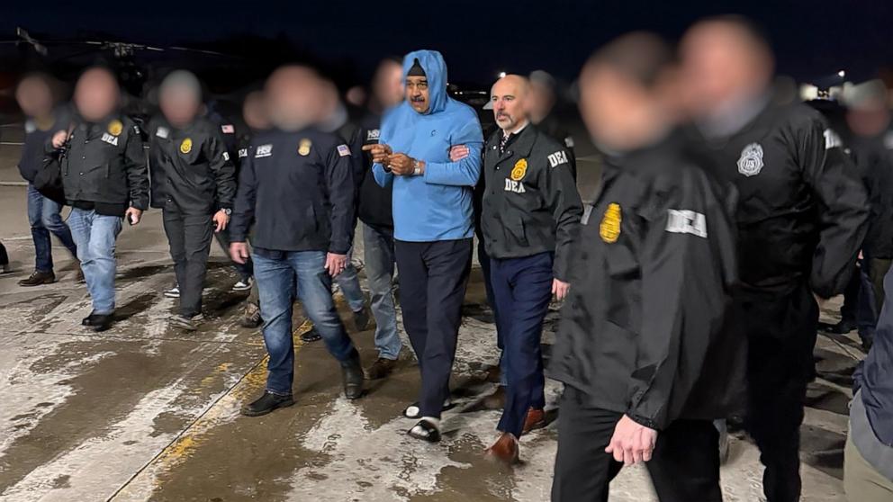 PHOTO: Venezuela's President Nicolas Maduro is escorted by Administrator of the U.S. Drug Enforcement Administration, Terry Cole after arriving at Stewart Air National Guard Base in Newburgh, New York, January 3, 2026. 