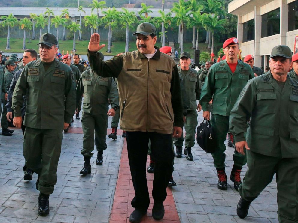 PHOTO: Venezuelas President Nicolas Maduro, center, greets military troops accompanied by Defense Minister Vladimir Padrino, left, at the Fuerte Tiuna in Caracas, Venezuela, May 2, 2019, in a photo released by the Miraflores Palace press office.