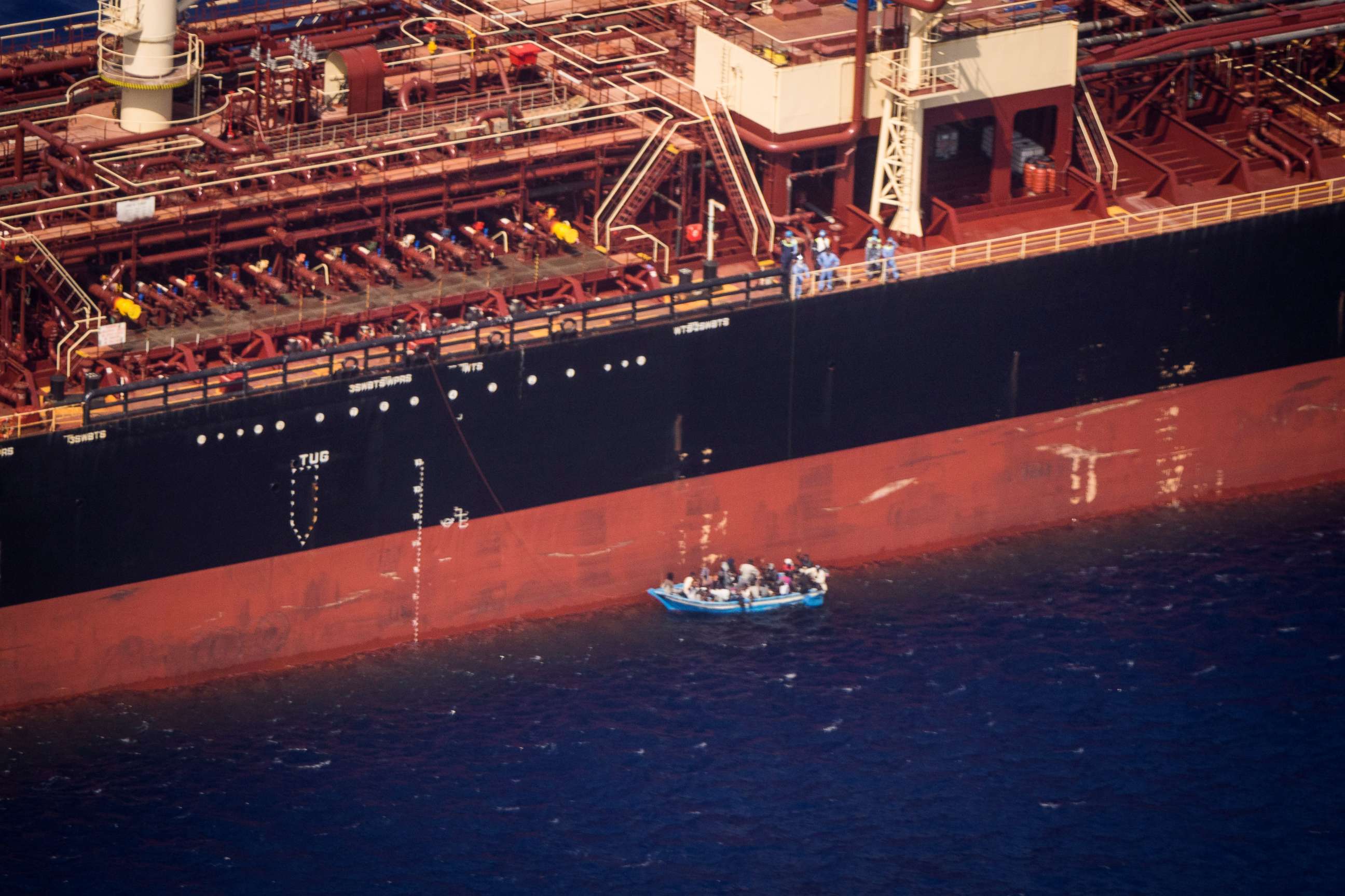 PHOTO: An aerial view shows migrants sitting in a boat alongside the Maersk Etienne tanker off the coast of Malta, Aug. 19, 2020.
