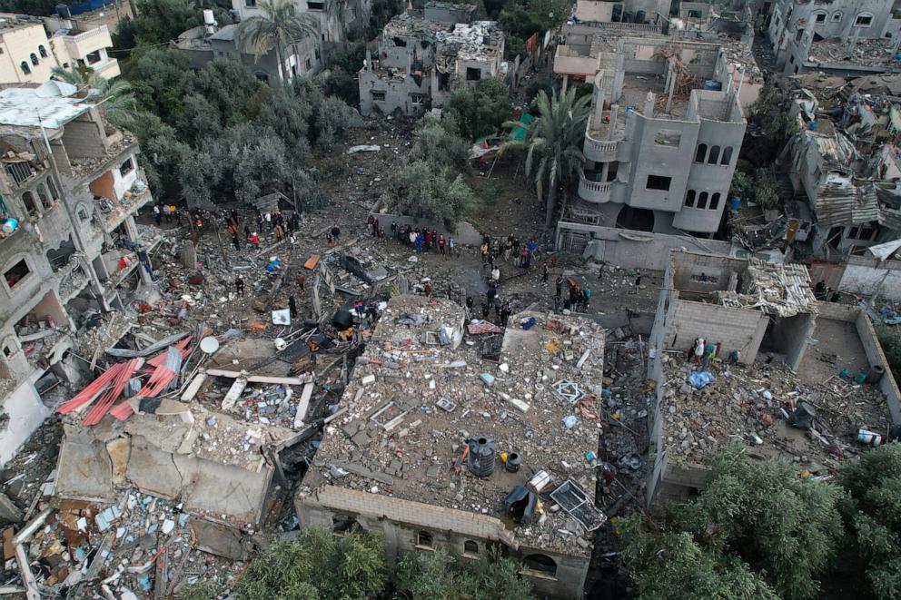 PHOTO: An aerial view shows Palestinians inspecting the damage from an overnight Israeli airstrike at the Al-Maghazi refugee camp in the central Gaza Strip, east of Deir al-Balah, on Dec. 25, 2023.