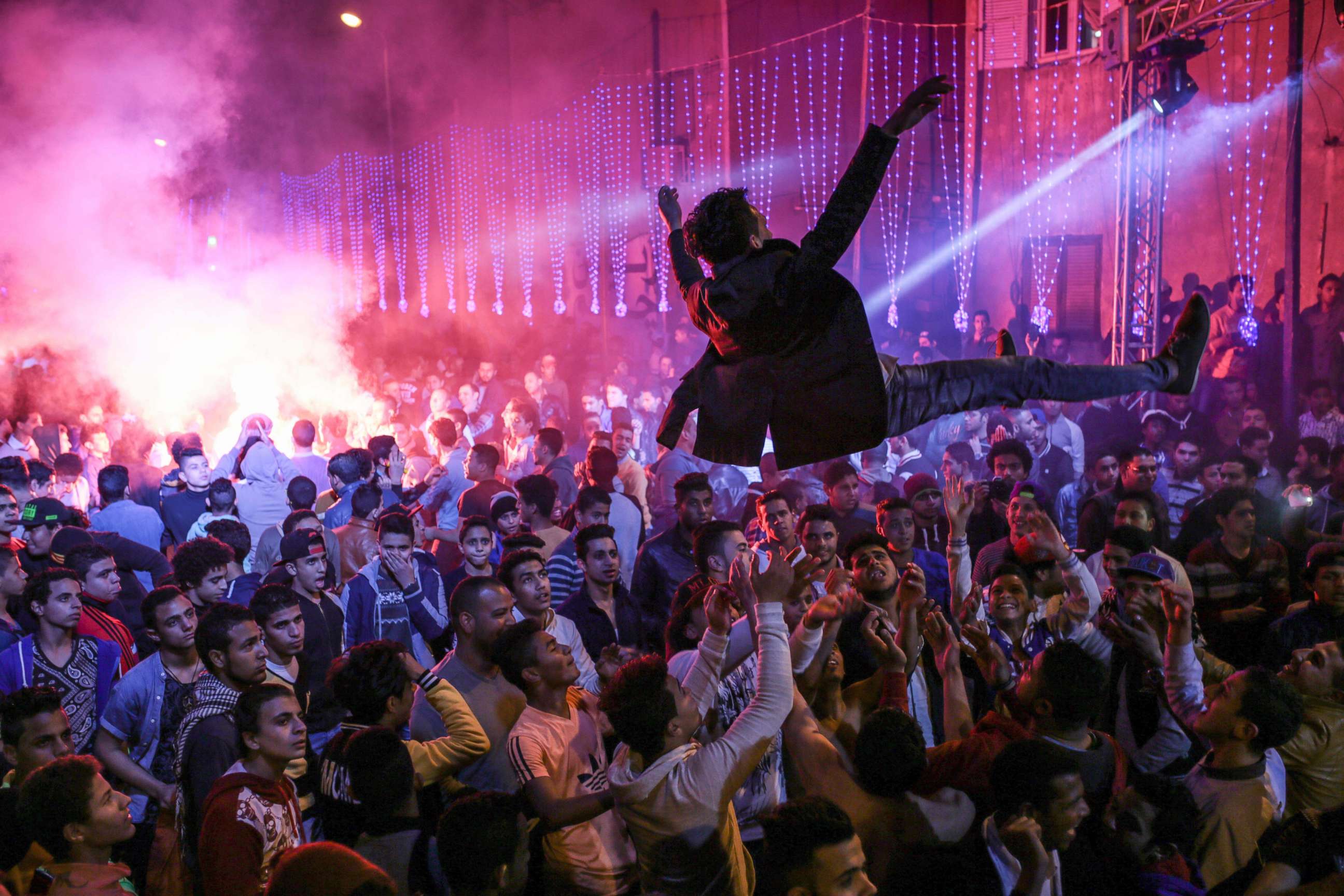 PHOTO: In this Thursday, March 5, 2015 photo, youth dance at a local wedding in Salam City, a suburb on the outskirts of Cairo.